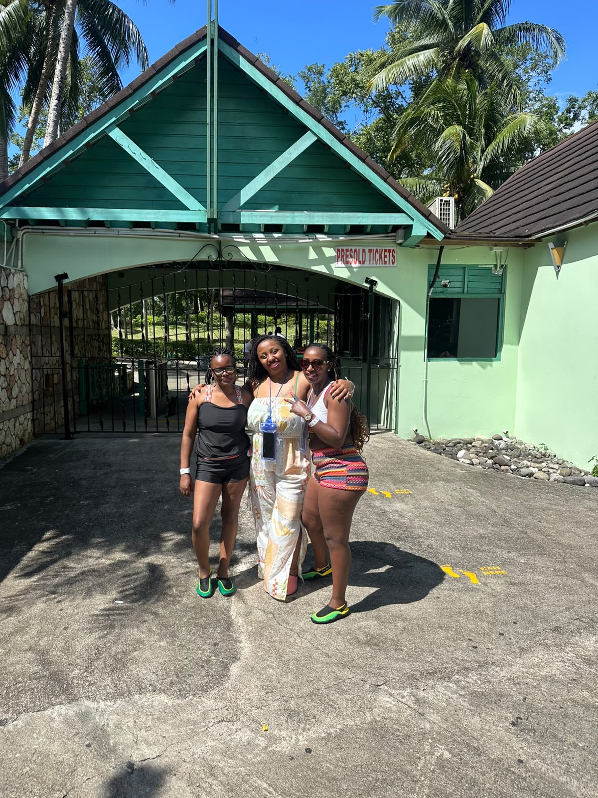 Three D-Xaymaca guests smiling at a Jamaican attraction entrance