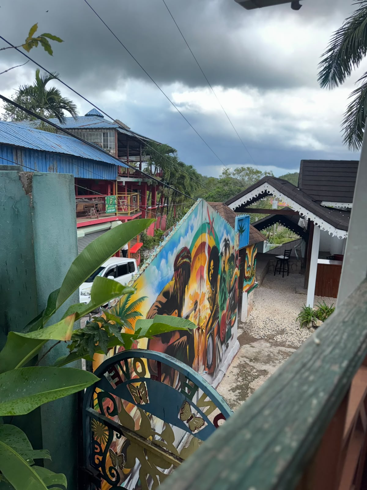 Vibrant Bob Marley mural in Jamaica surrounded by lush greenery